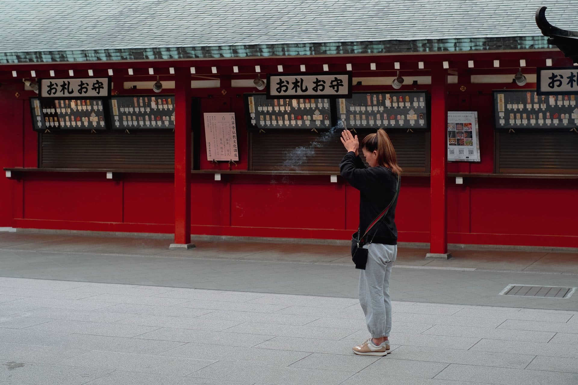 A visitor bowing in prayer at a Japanese shrine
