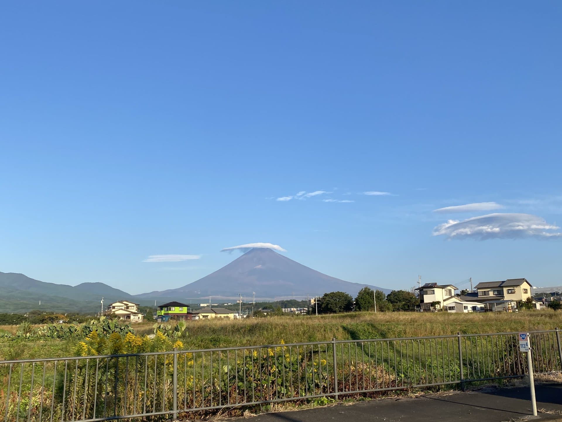 Mount Fuji rising above a quiet residential neighbourhood in Japan on a clear morning