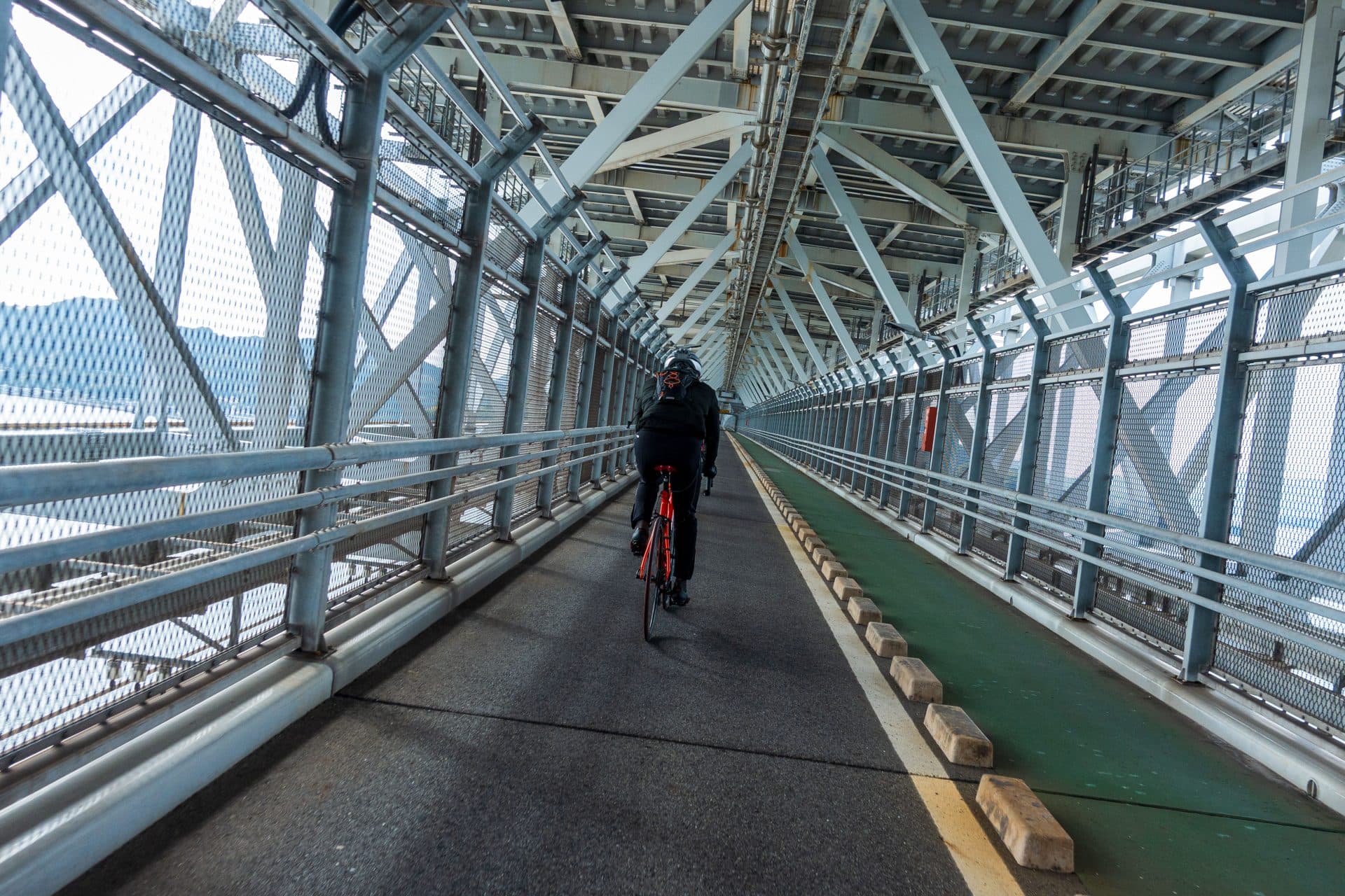 Man in black jacket riding a bike