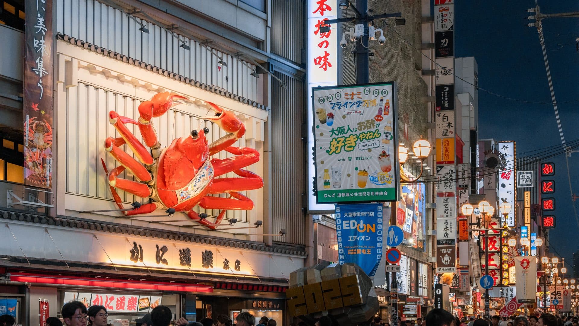 Bustling osaka street with giant crab sign at night