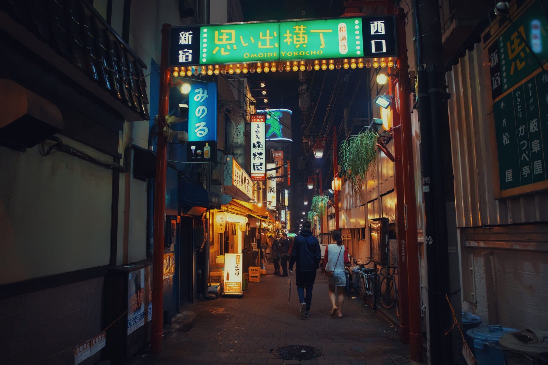 People in alley on bazaar at night