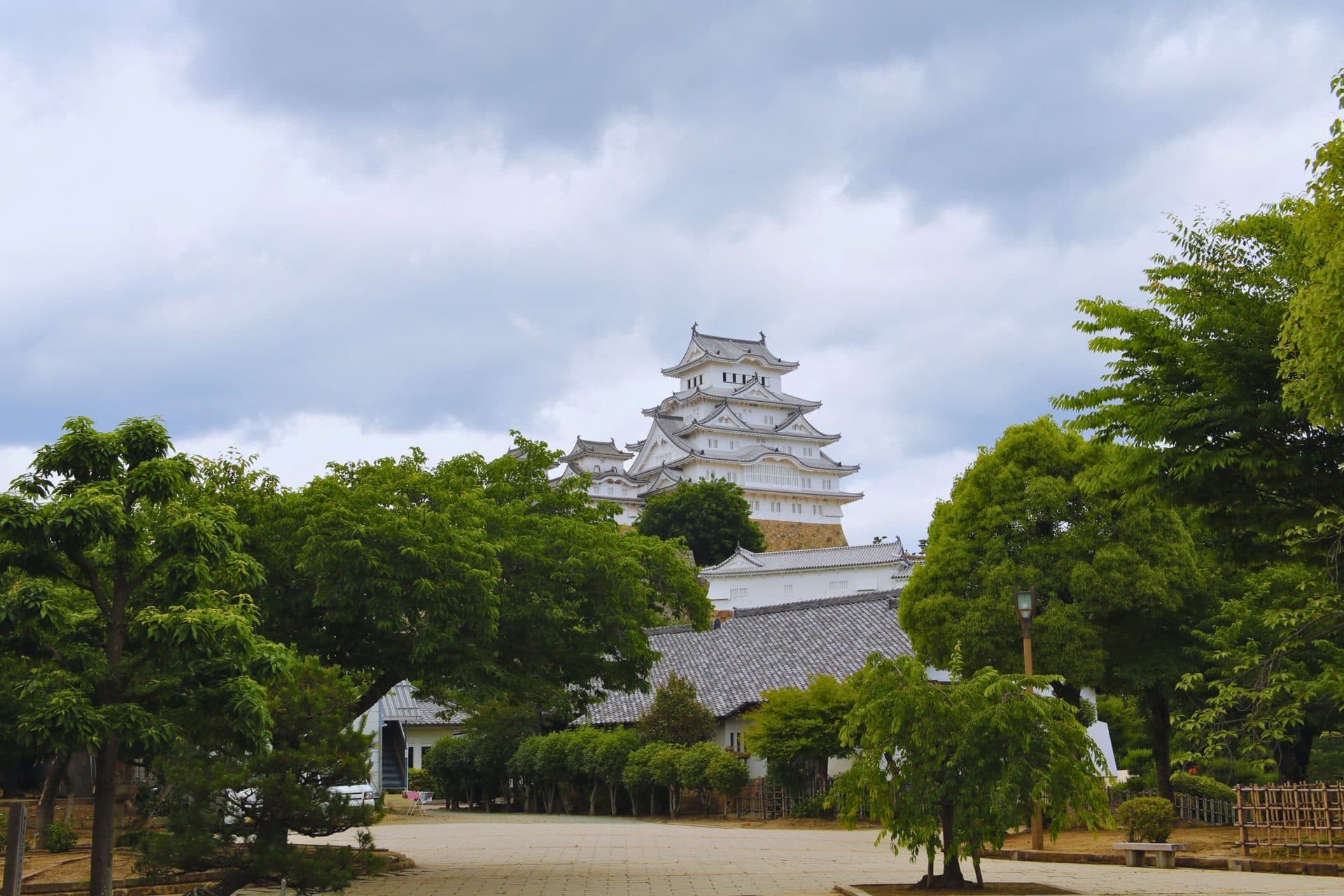 View of himeji castle surrounded by lush greenery