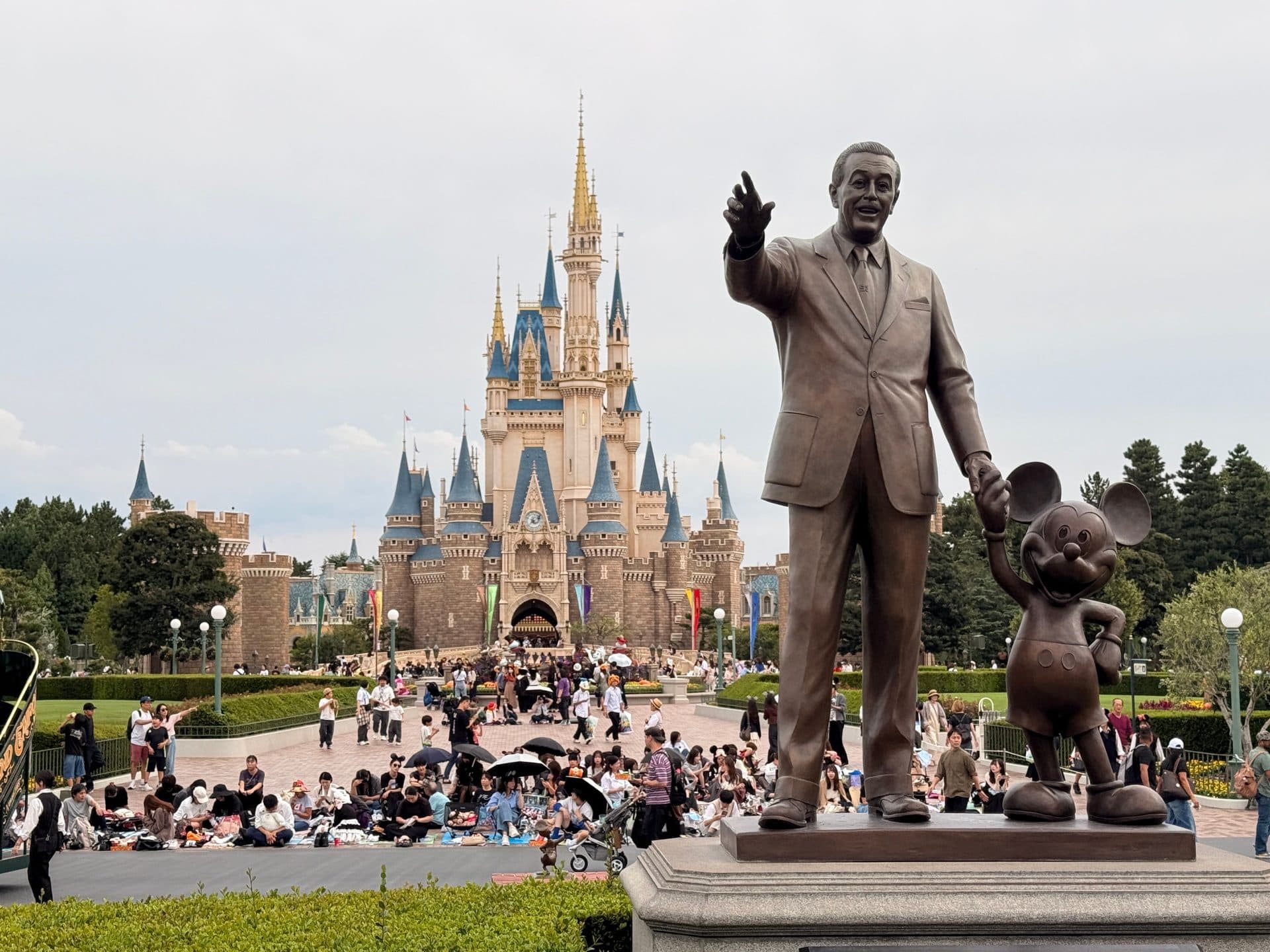 Cinderella Castle at Tokyo Disneyland with visitors gathered in the plaza