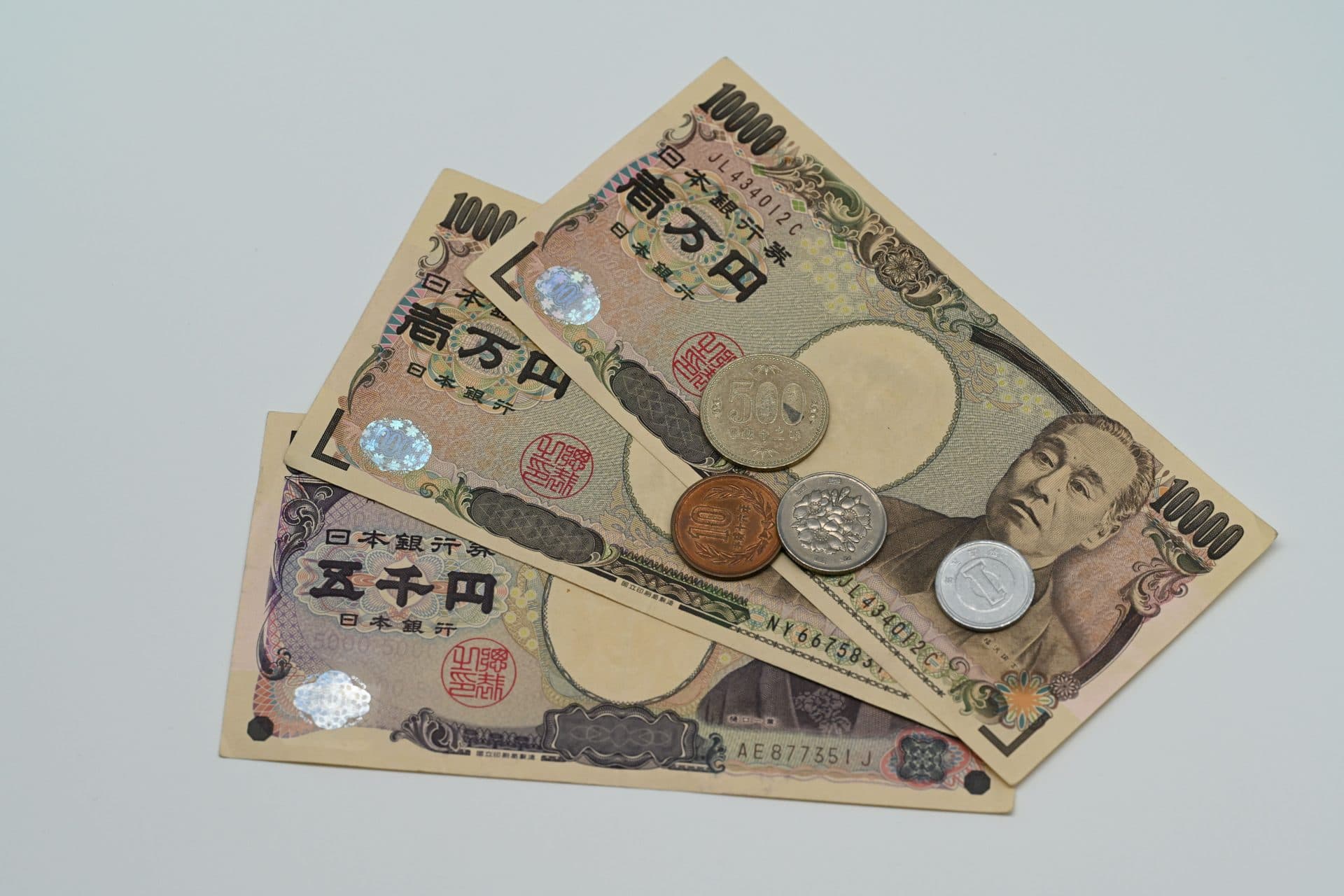 Close-up of Japanese yen banknotes and coins arranged on a flat surface