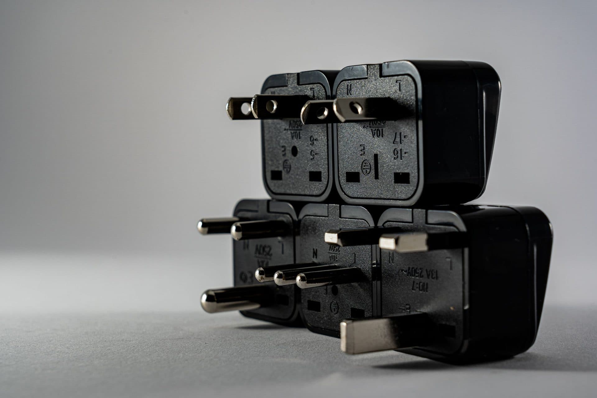 Close-up of black electrical adapters stacked together