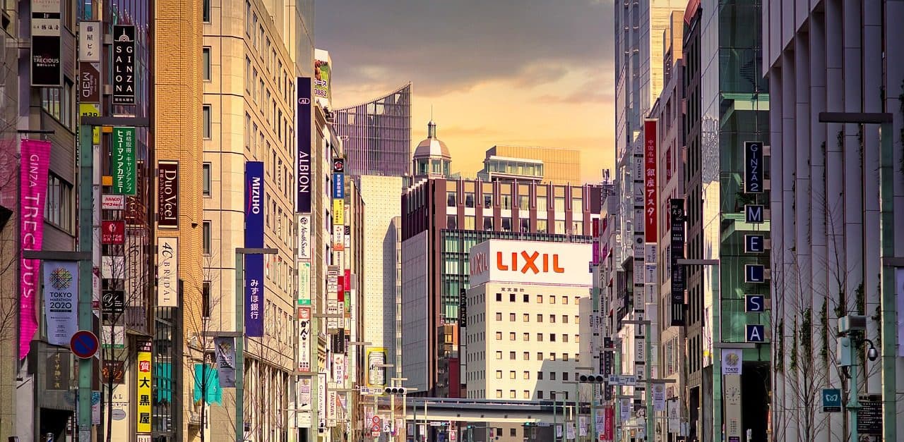 Chuo-dori in Ginza, Tokyo, lined with shop and bank signs under an evening sky